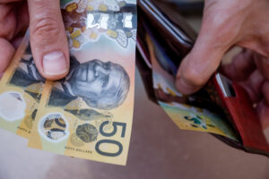 Hands,holding,australian,dollars,50,banknotes.,finance,and,payment,concept.
